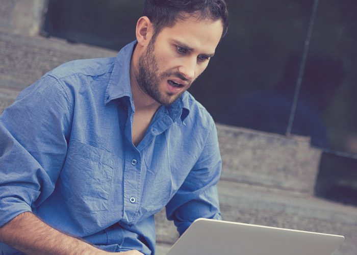 stressed man with laptop