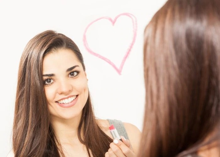 happy girl looking at the mirror