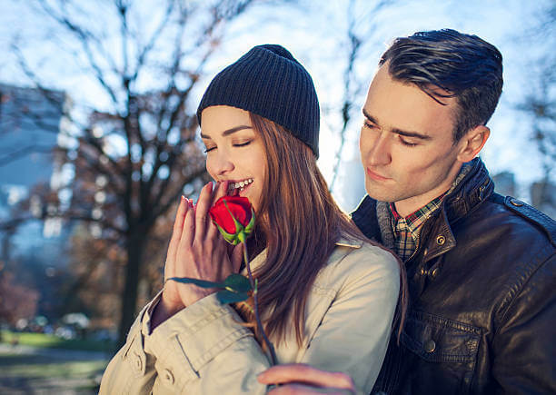 a man gives a rose to a girl