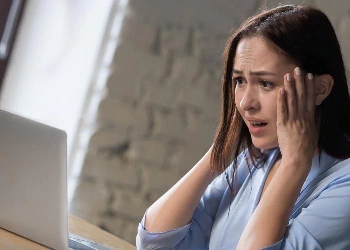 scared woman with laptop