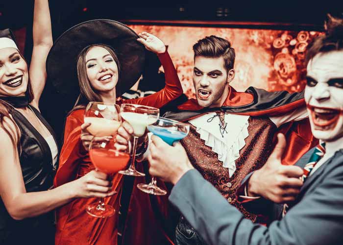 2 happy couples drinks in halloween outfit
