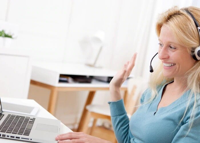 happy woman with laptop communicates online