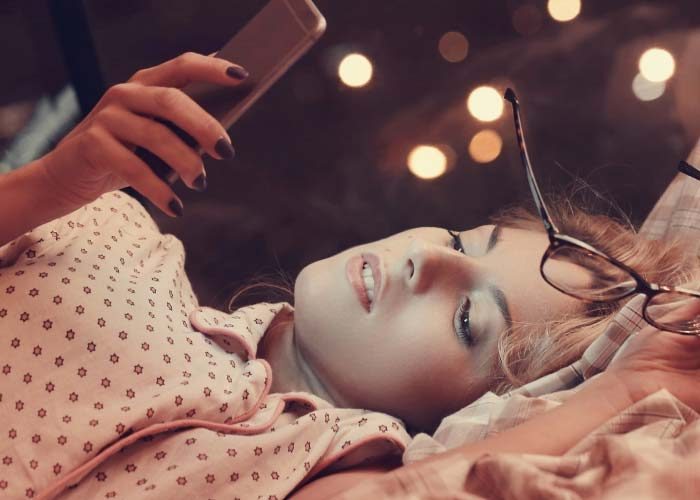 girl lying with phone