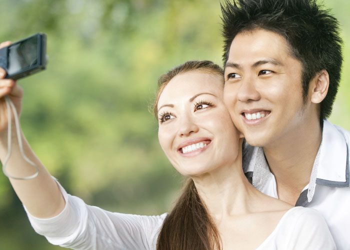 asian couple takes selfie