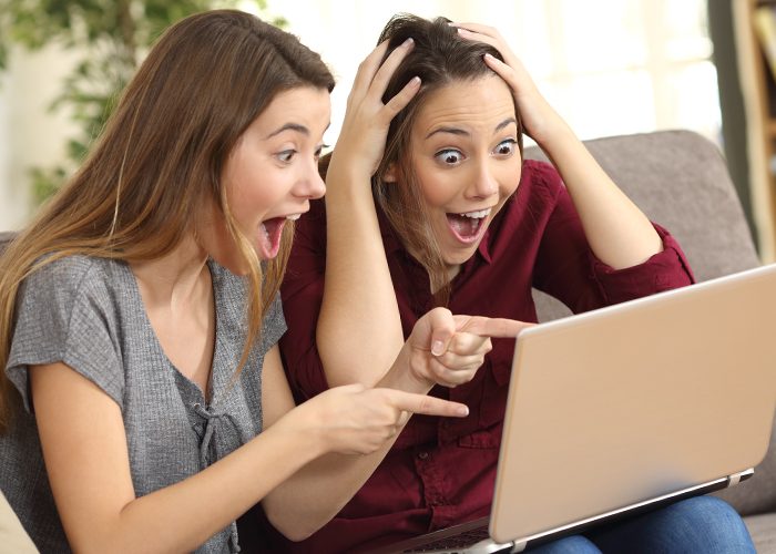 two laughing women with laptop