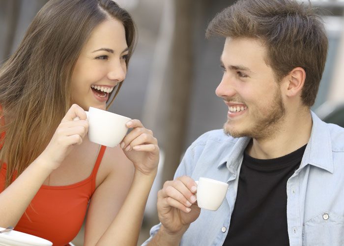 happy cople drinks coffee