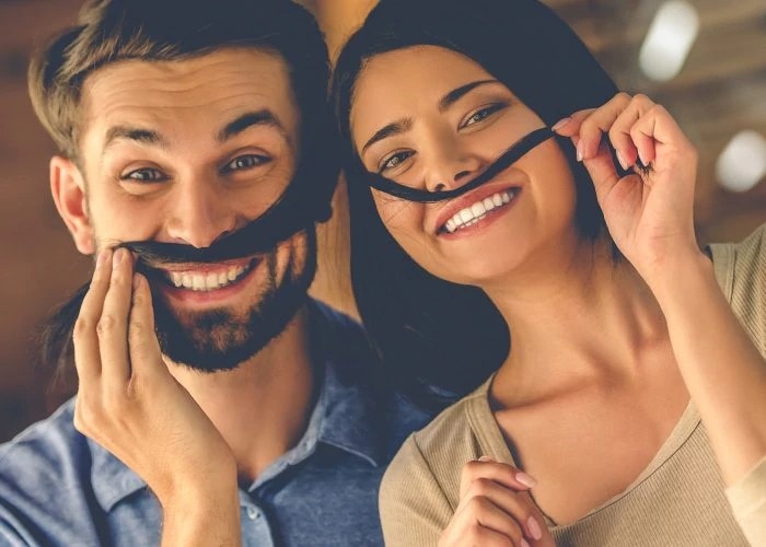 happy couple playing with hair