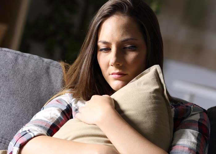 woman hugs pillow