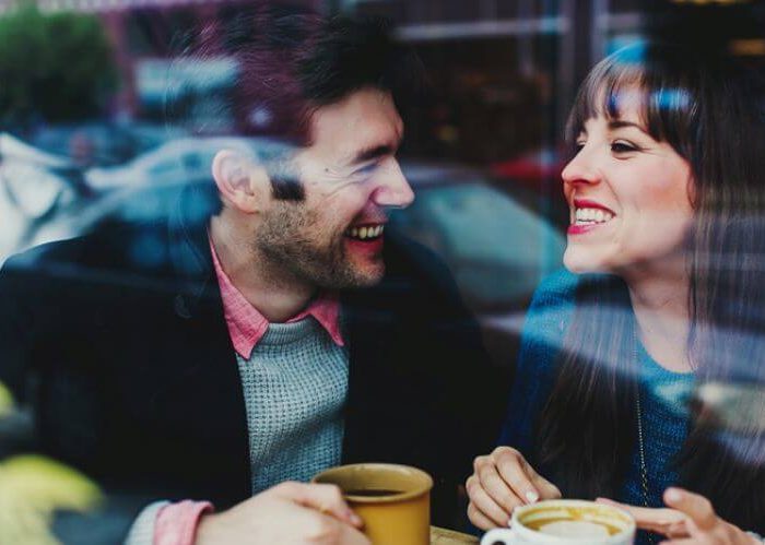 woman drinks cofee with man