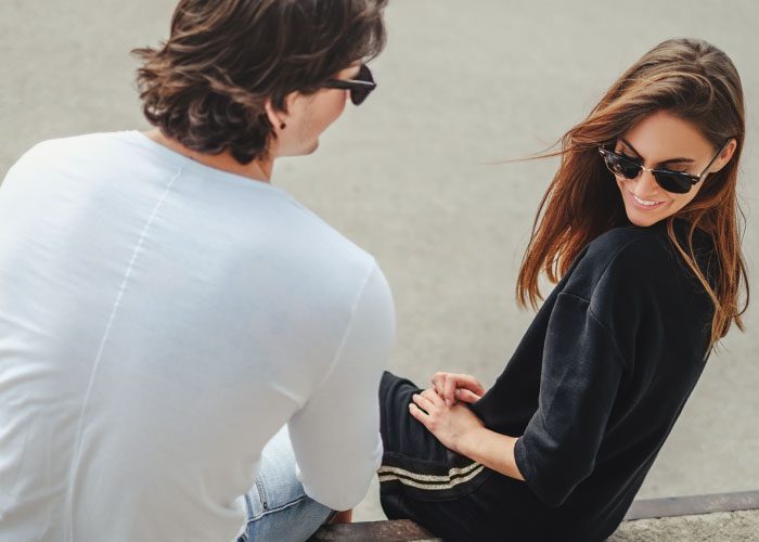 long hair guy and woman in sunglasses